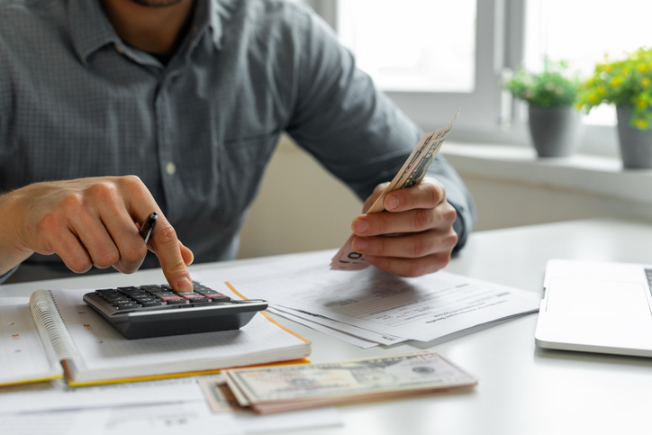 A man counting money decides whether a Coverdell ESA is right for his family's needs. 