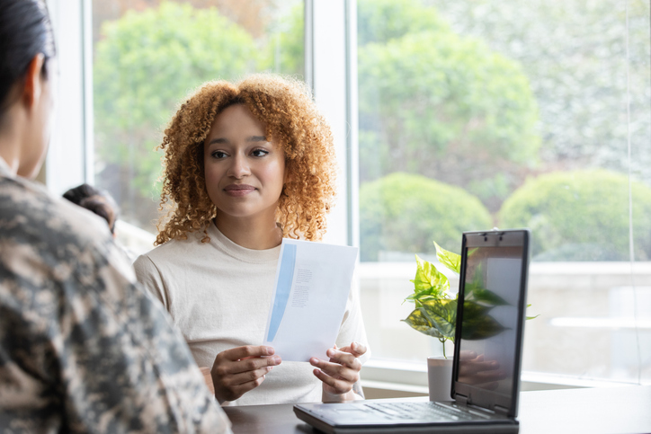 A soldier creating a trust with a financial advisor.