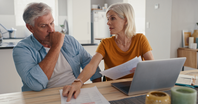 A couple reviewing their real estate investment portfolio.