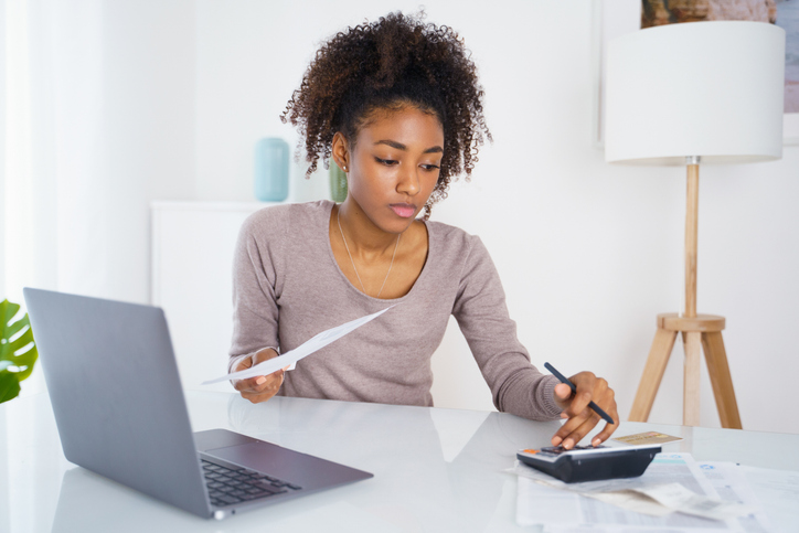 A young employee researching her eligibility for her company's 401k student loan match program.
