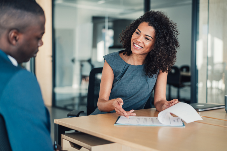 A real estate investor reviewing his portfolio with a financial advisor.