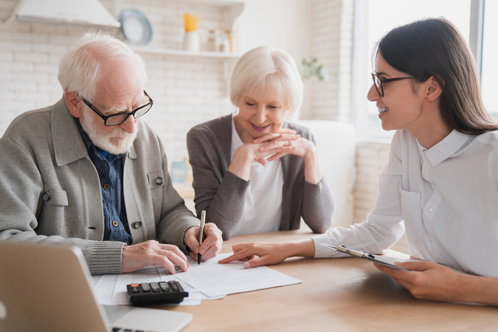 A senior couple meeting with an advisor to update their estate plan.