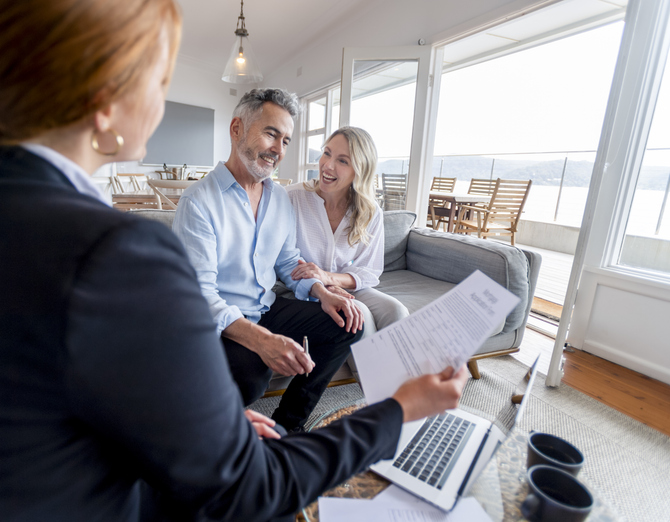 Real estate investors working with an advisor to create an investment plan.