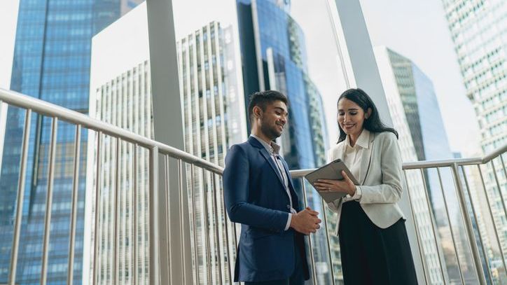 An investor speaks with his real estate agent about a multi-family property he recently toured.