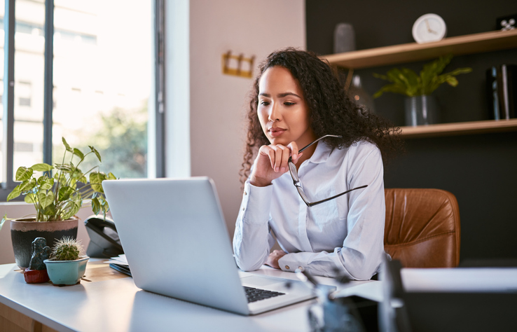 A woman researches books on building wealth. 