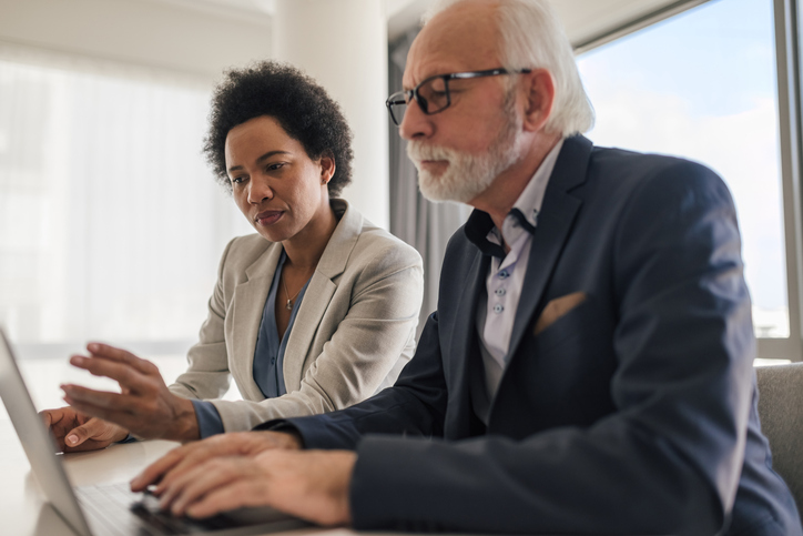 A senior client diversifying his portfolio with an advisor.