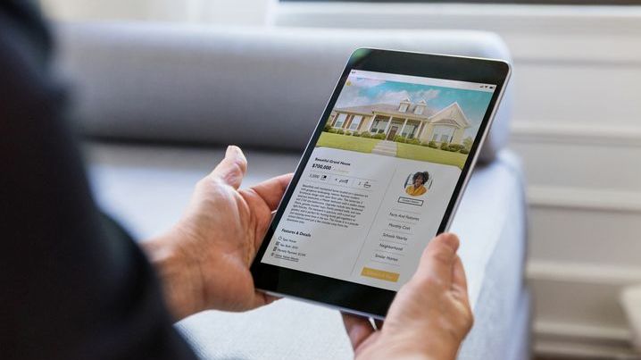 A prospective homebuyer looks at a home listing on their tablet.