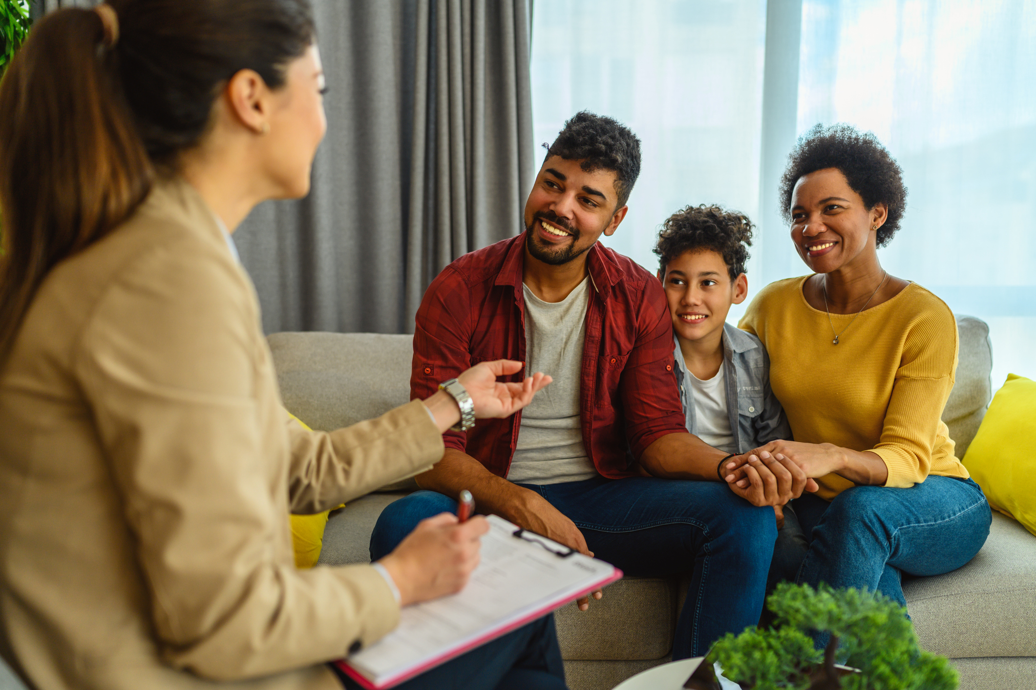A young family meets with a financial advisor to create an estate plan.
