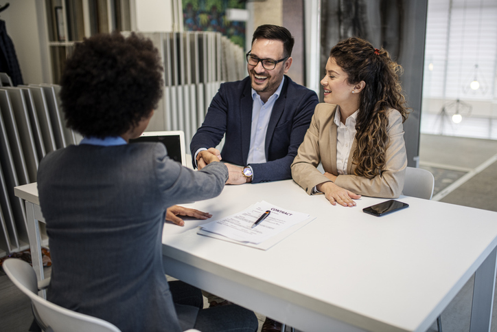 Real estate investors reviewing investment options with an advisor.