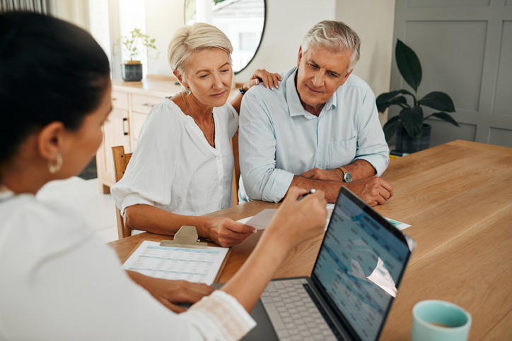 A couple consult with their advisor on whether they need to file Form 56. 