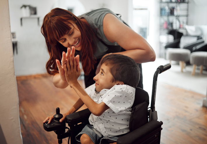 A guardian takes care of a special needs child.