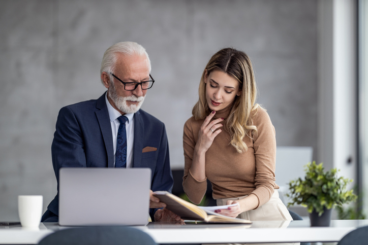 A senior client working with a financial advisor to balance work and retirement.