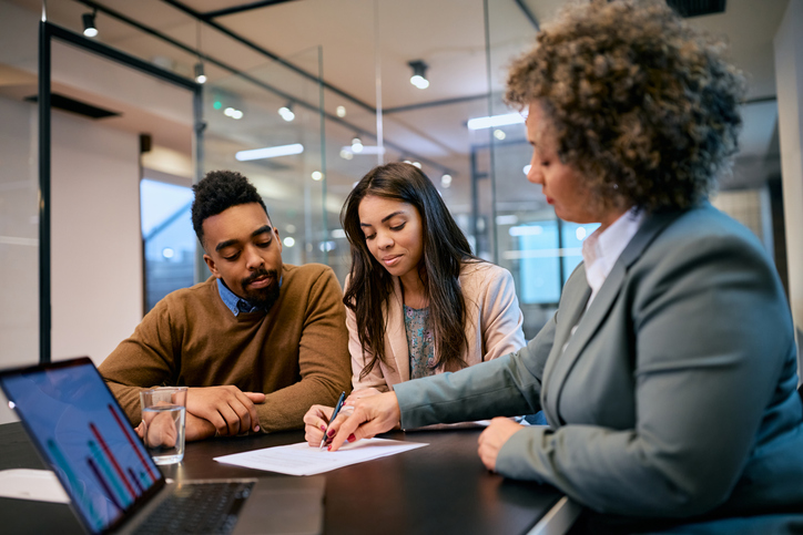 A couple creating a new will with their advisor. 