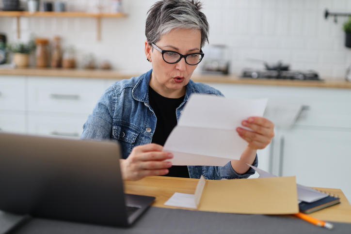 A woman reviewing her 401(k) account balance in a statement.