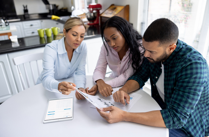 A couple consulting a financial advisor about creating an estate plan in Colorado.