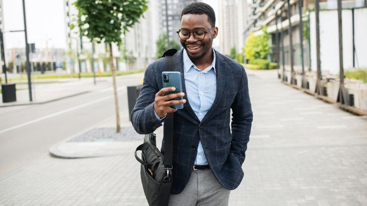 A real estate wholesaler looks at property listings on his phone.