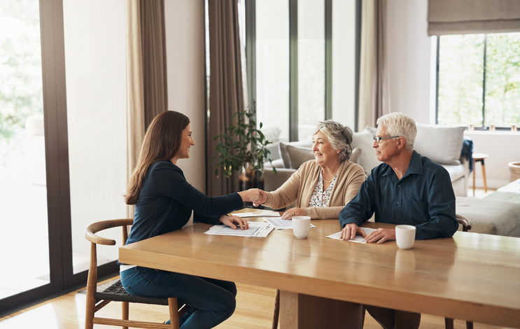 A couple meets with their advisor to discuss estate planning for seniors.