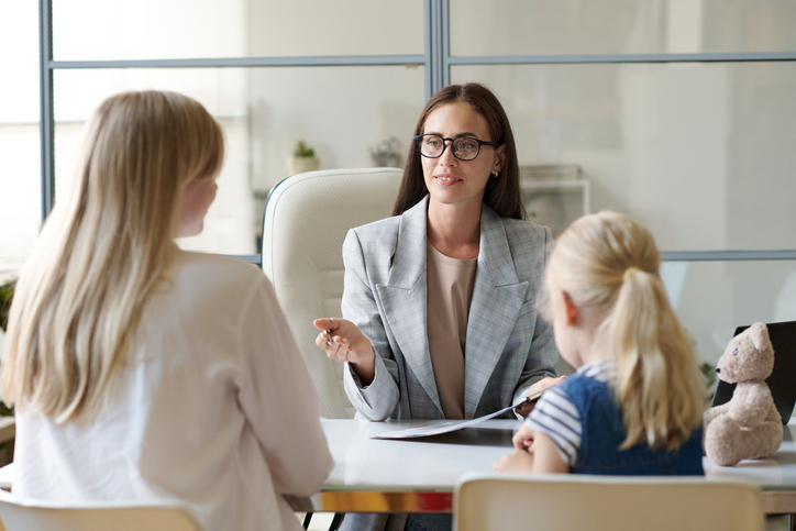 A parent meeting with a financial advisor to discuss creating an estate plan for her child. 