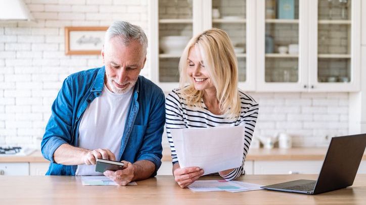 A couple looks over their savings accounts to determine how they can save more money.