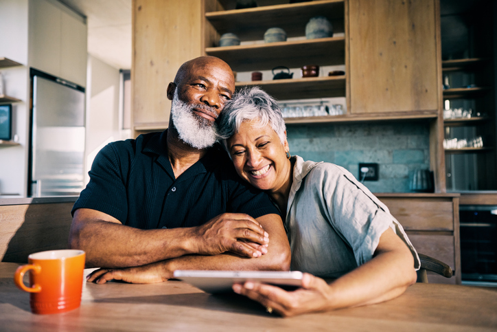 A retired couple in their 60s reviewing their retirement plan. 