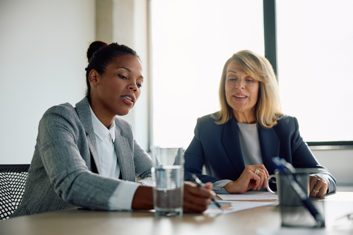 Two values-based advisors discussing a financial plan for clients.