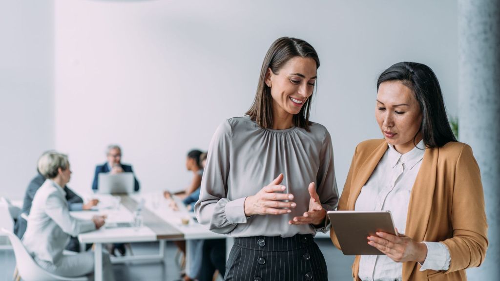 Business partners discuss the financial management of their company. 