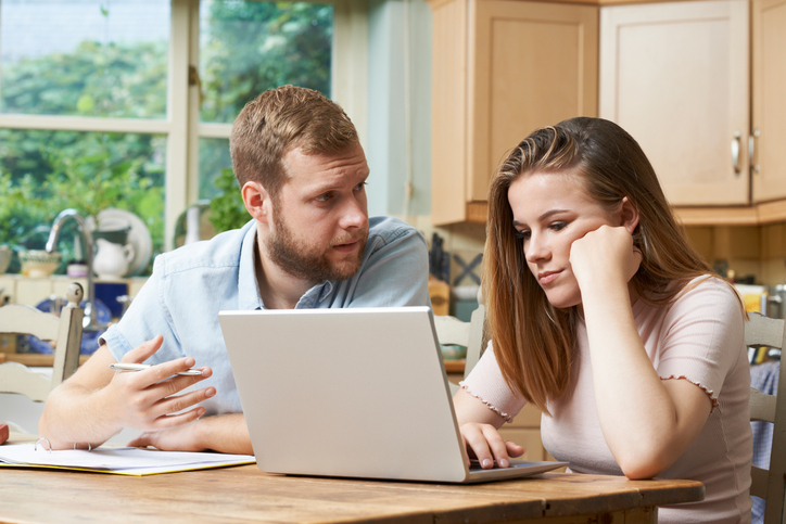 A couple discussing debt consolidation options.