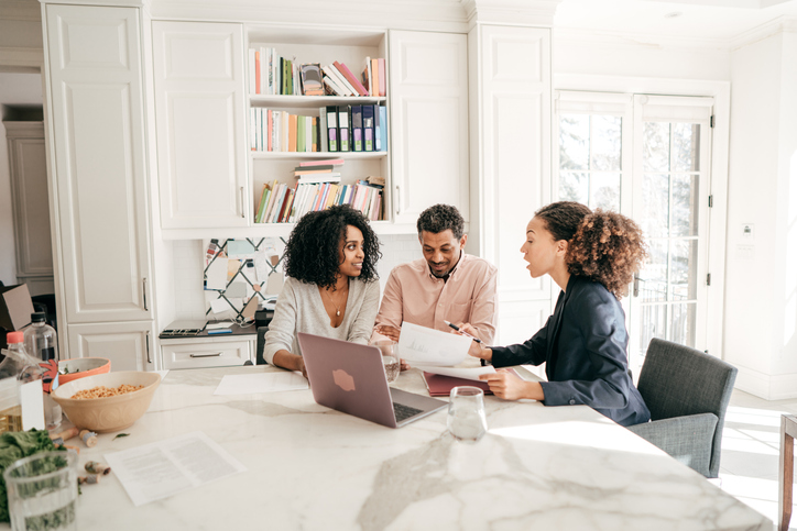 A real estate lawyer works with clients on a foreclosure.