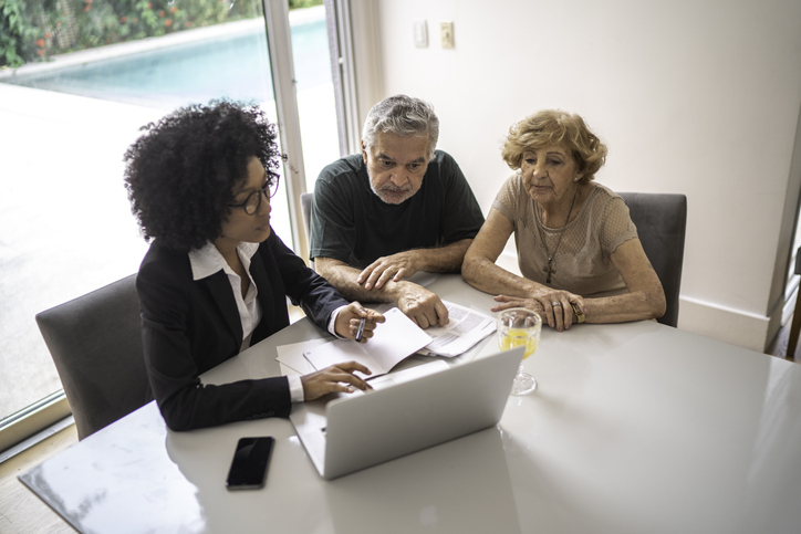 Clients meeting with a financial advisor to discuss strategies that can help them avoid capital gains.