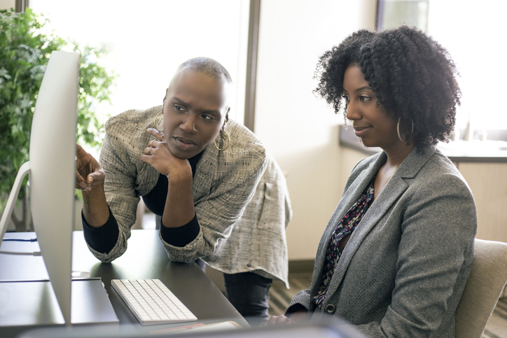 A financial advisor reviews a financial plan with a client.