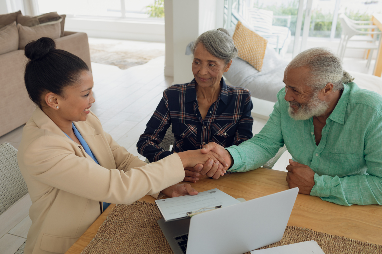 A senior couple meeting with an advisor to review mortgage options for their retirement.