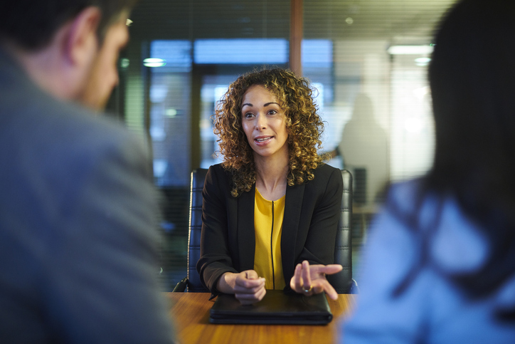 A financial advisor reviewing an investment portfolio with clients.