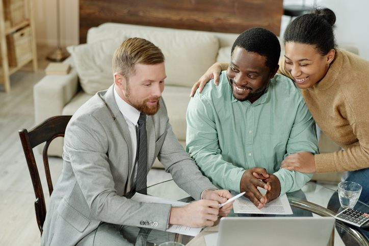 A couple meeting with an advisor to review an estate plan.