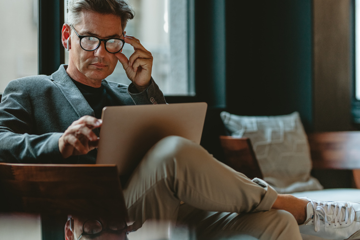 A man reviewing options trades on a virtual platform.