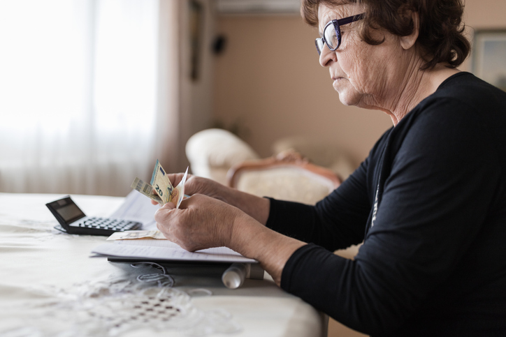 A woman counting money, considers how retired people make money.