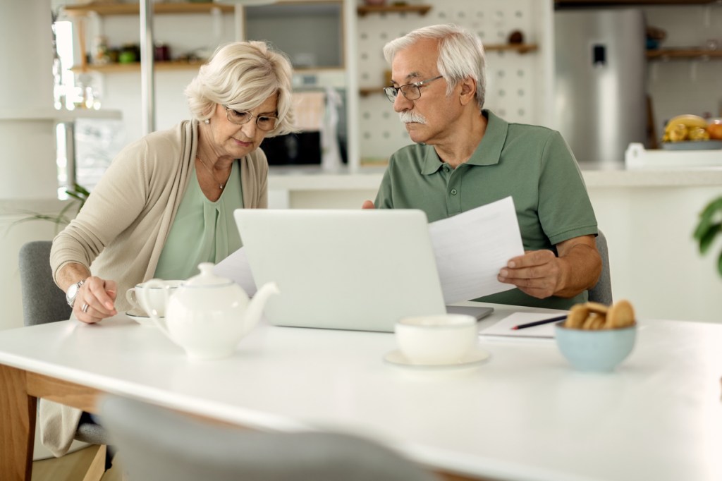 A senior couple reviewing their retirement budget.