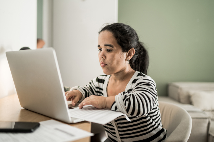 An investor looking up returns for her investments.