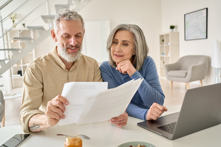 A retired couple reviews financial planning tips for seniors.