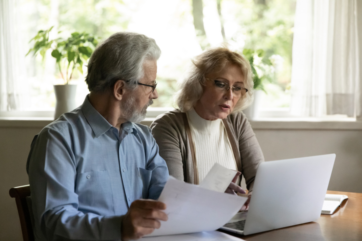 A senior couple reviewing their indexed universal life (IUL) policy.