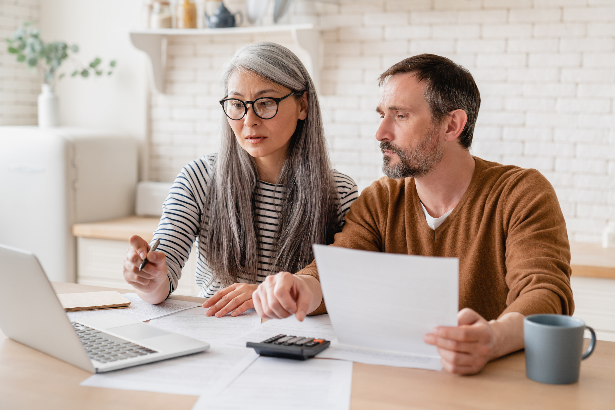 A couple reviewing automated business investments.