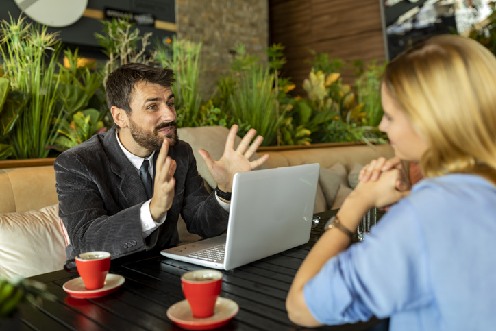 An investor discussing net expense ratios with a financial advisor.