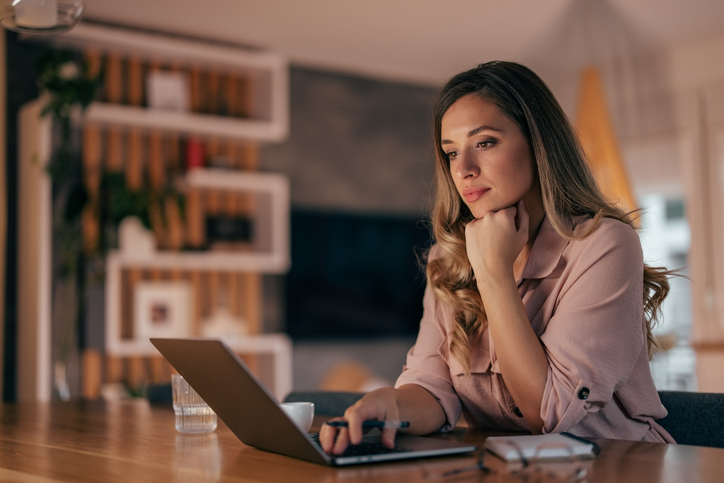 A woman looking up unexpected retirement expenses.