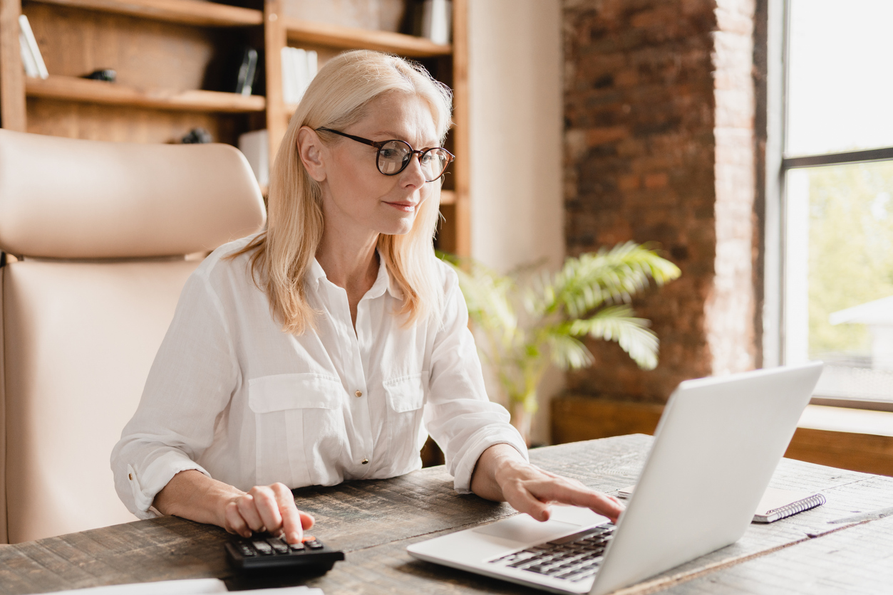 A woman reviewing whether she has made a 401(k) contribution error.