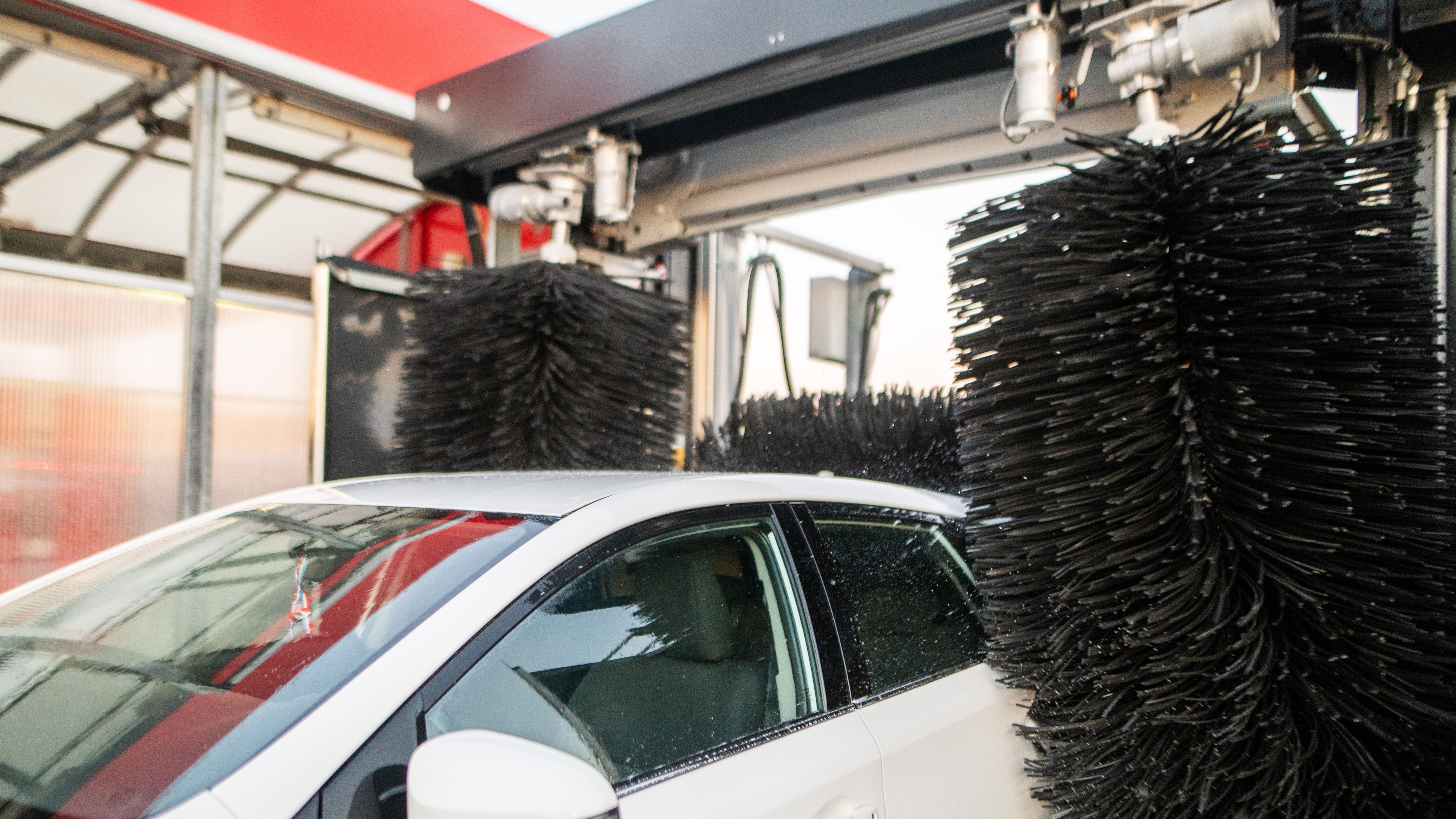 A car goes through an automatic car wash. 