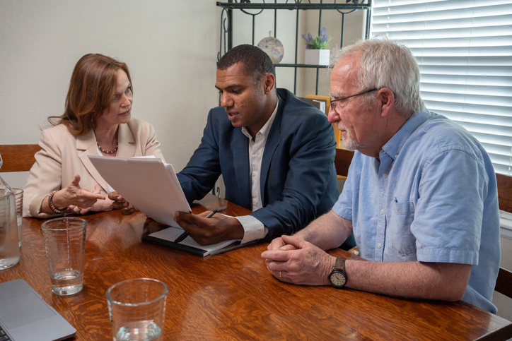 A financial advisor reviewing a retirement plan with a senior couple.