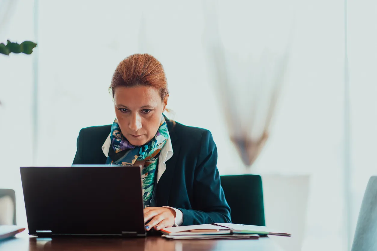 A woman looking up steps to lower her debt-to-income ratio.