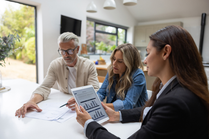 Real estate investors meeting with a financial advisor to discuss tax planning strategies.