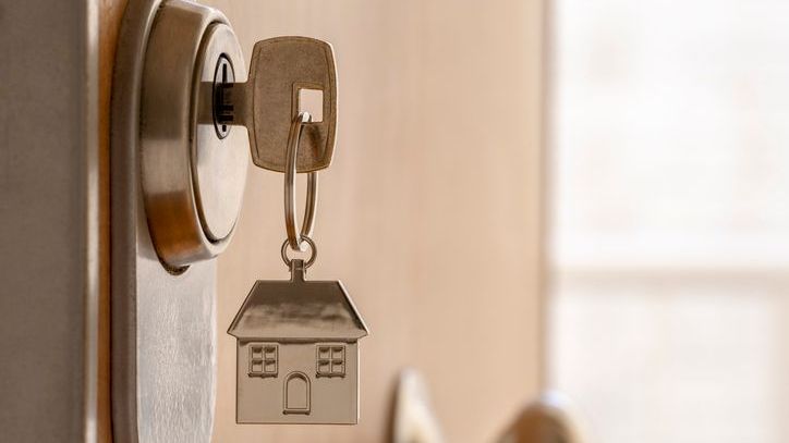 A house key hangs in the front door of a vacation home that was recently purchased.