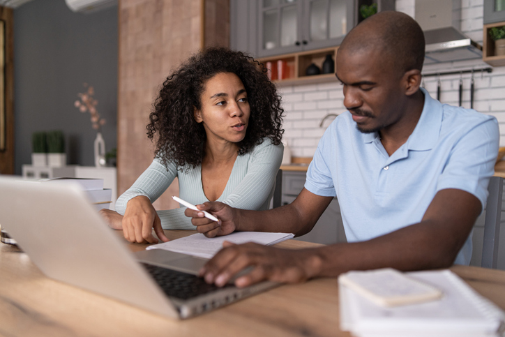 A couple buying short-term rental insurance.