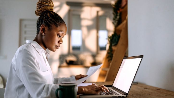 A woman reviews her finances while crafting a financial plan for herself.